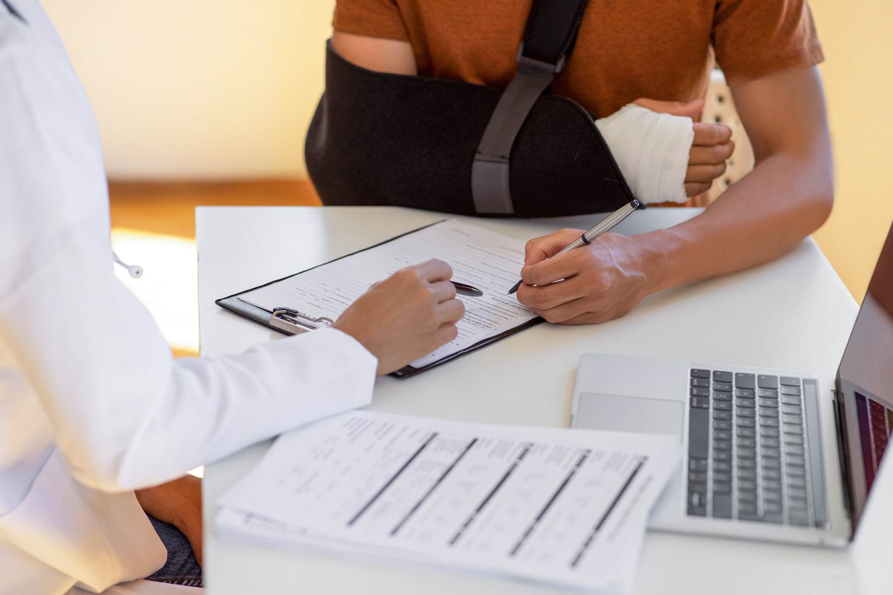 A doctor consulting with a patient about medical records at Sammons Injury Law