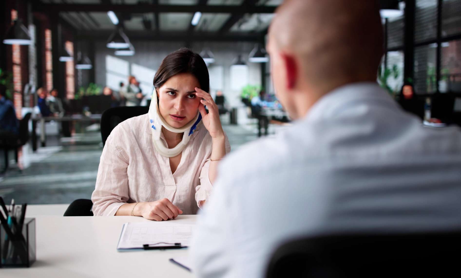 n unhappy woman consulting a lawyer about a traumatic injury in Apollo Beach, FL.