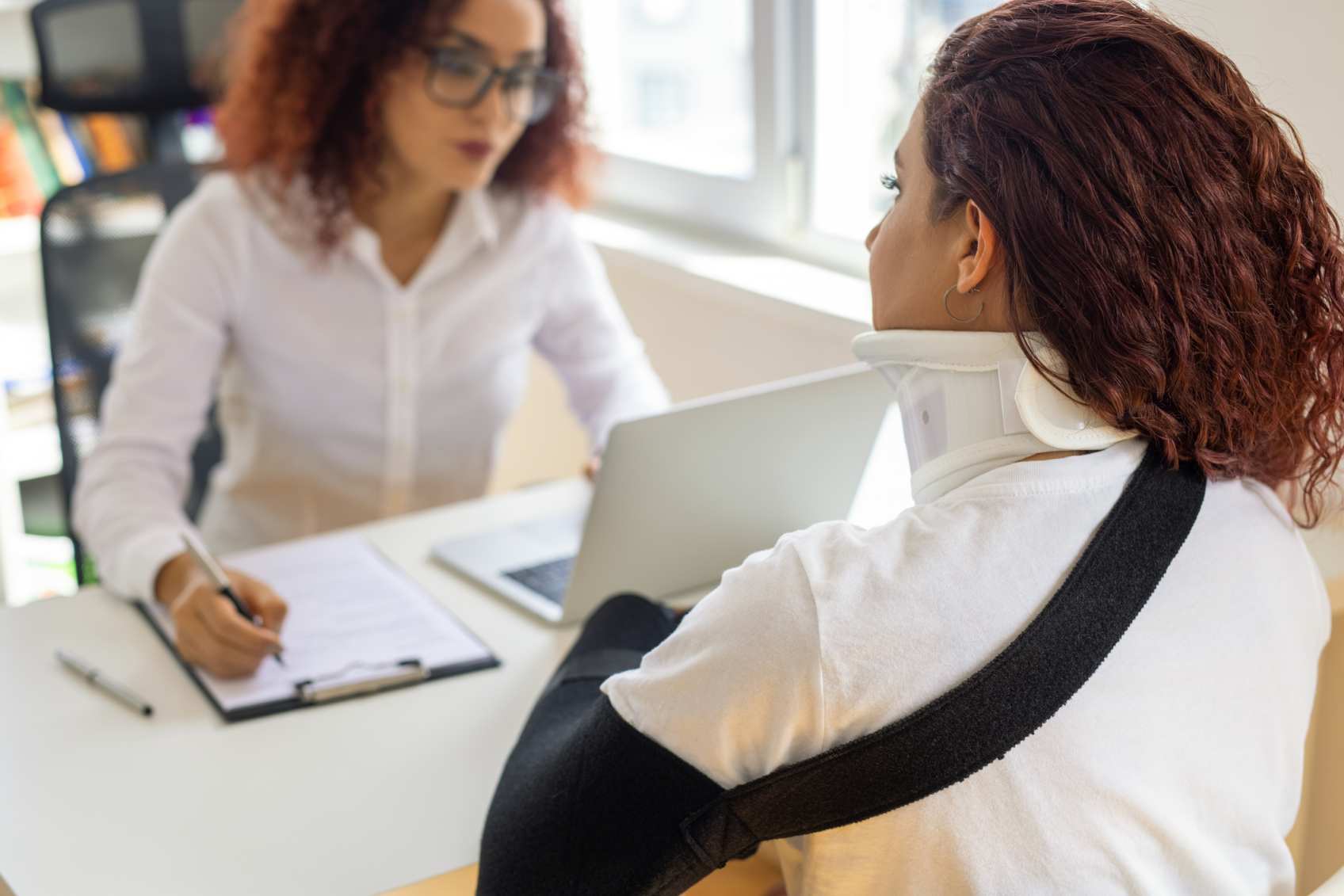 A worker discussing injury compensation with a lawyer in Apollo Beach, FL.